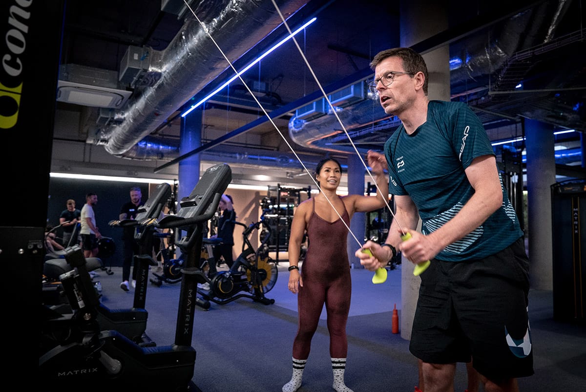 a middle aged Caucasian male using a tool in the gym