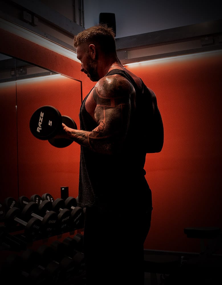 silhouette of a male lifting dumbbells