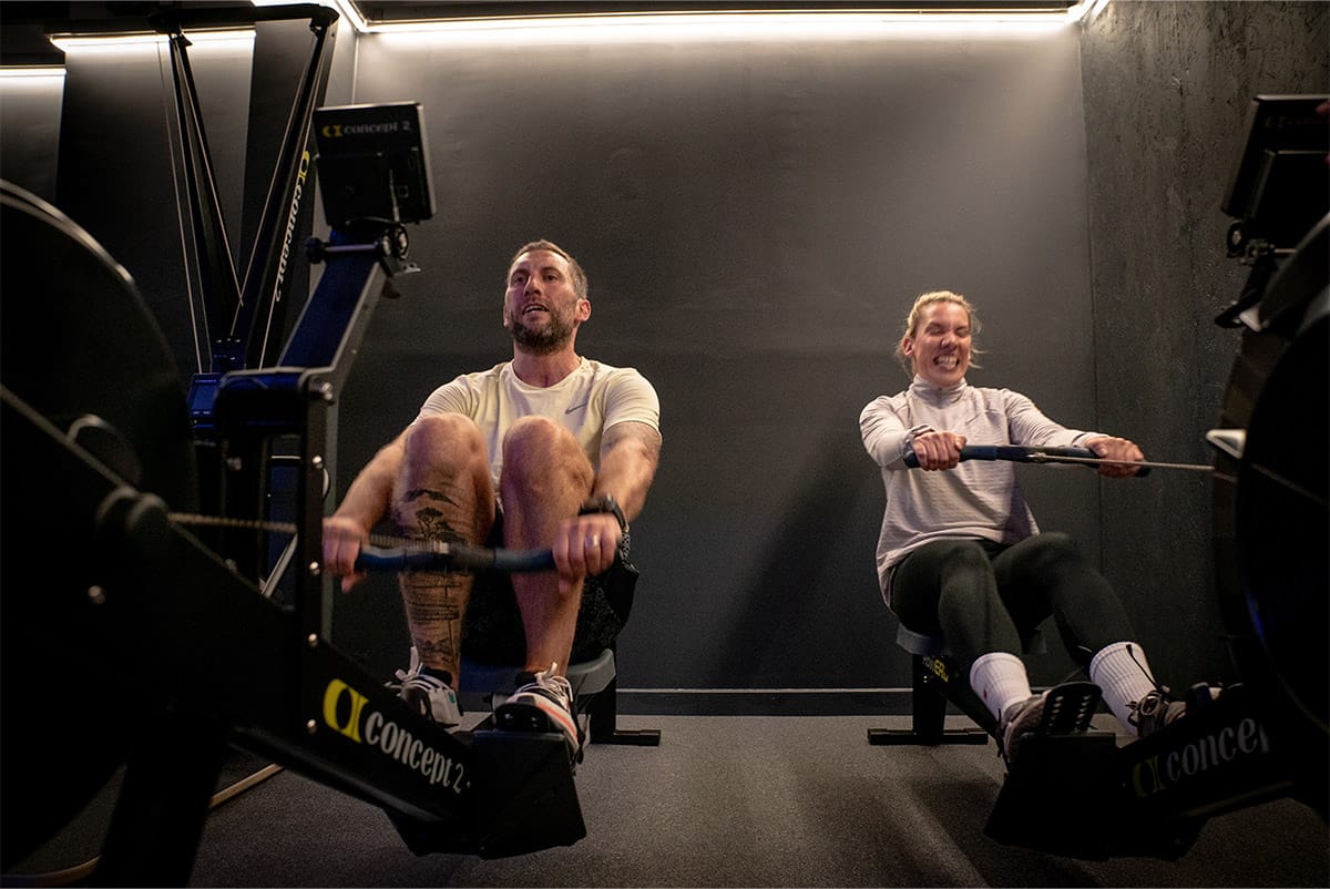 a man and woman on exercise equipment representing cardio class