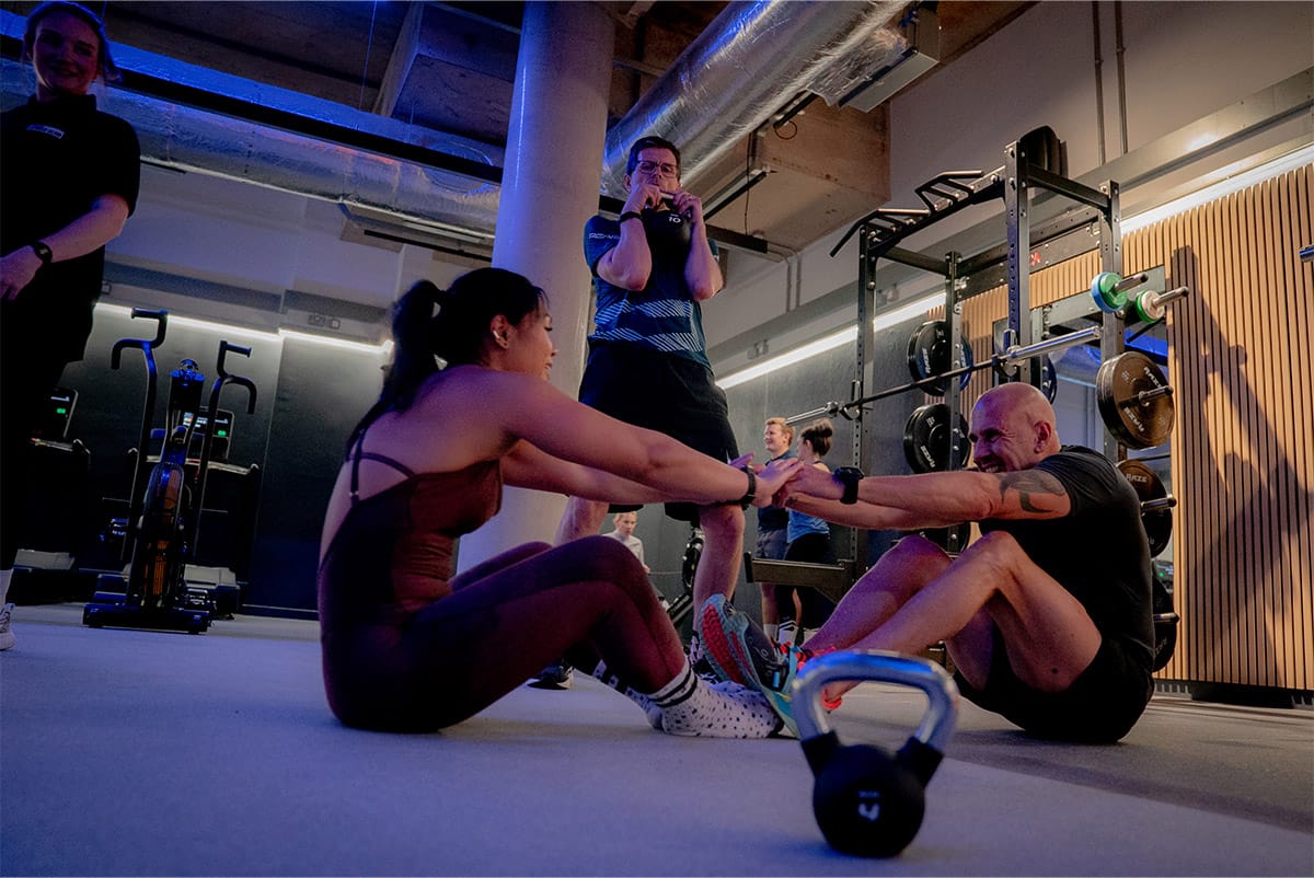 a group of people in a gym class working on endurance